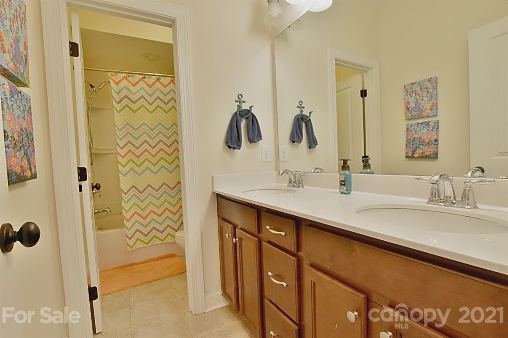 922 Castlewatch Drive Fort Mill, SC 29708 - Photo 18 of 38 a bathroom with a double vanity sink a mirror a shower and vanity