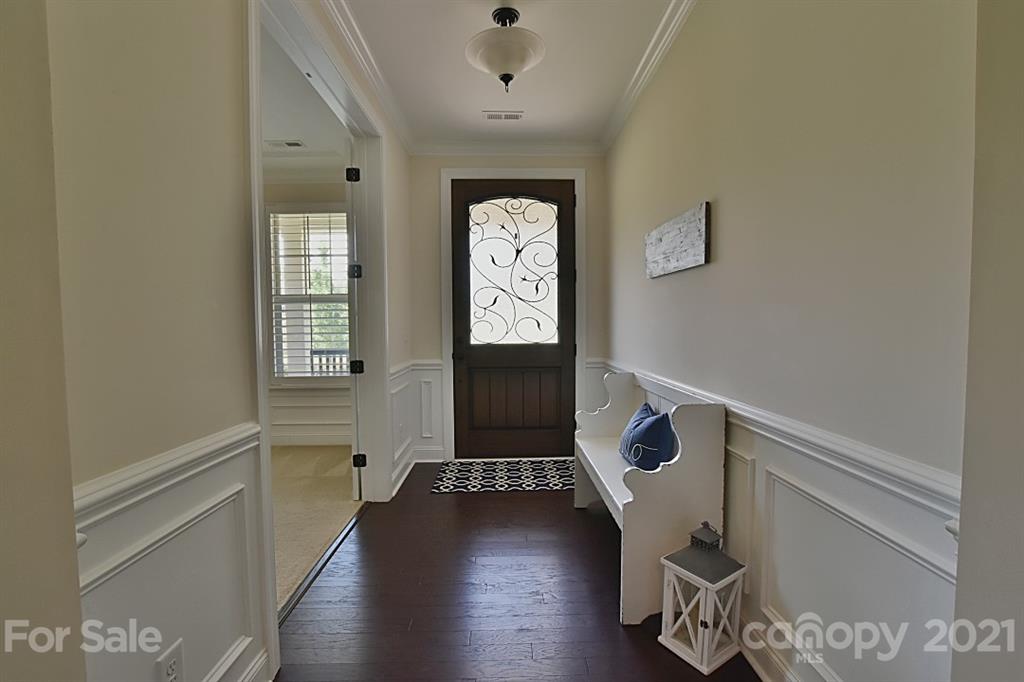 922 Castlewatch Drive Fort Mill, SC 29708 - Photo 4 of 38 a hallway with front door wooden floor and windows