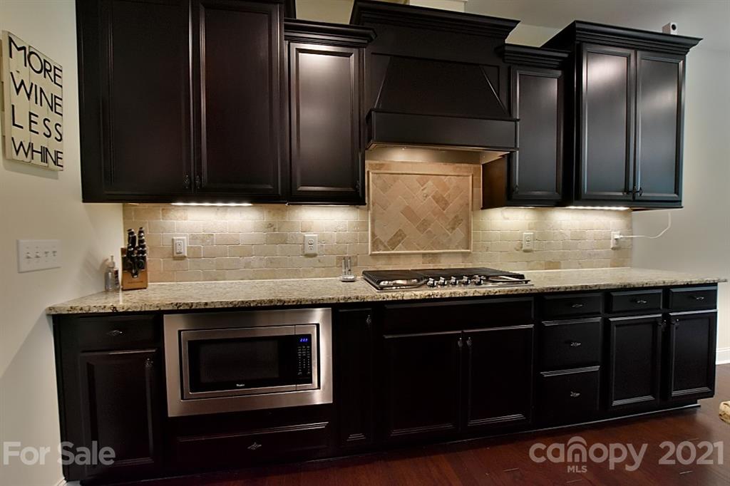 922 Castlewatch Drive Fort Mill, SC 29708 - Photo 10 of 38 a kitchen with granite countertop a stove top oven microwave and cabinets