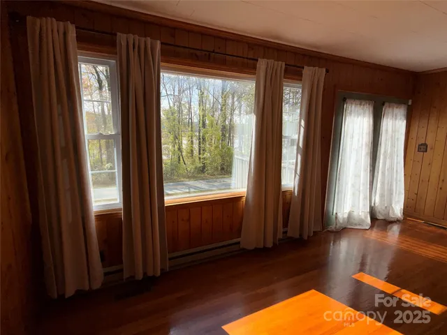 a view of a room with wooden floor and windows