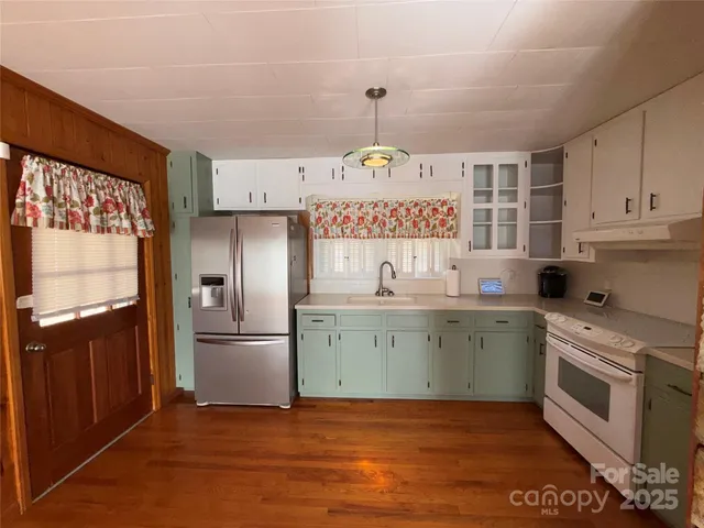 a kitchen with a sink stove and refrigerator