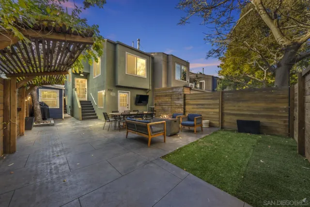 a view of a house with backyard and sitting area