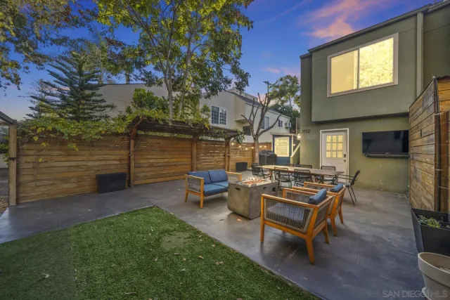 a view of a backyard with sitting area