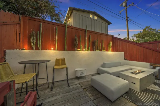 a backyard of a house with table and chairs