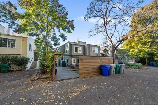 a view of a house with a tree in the yard