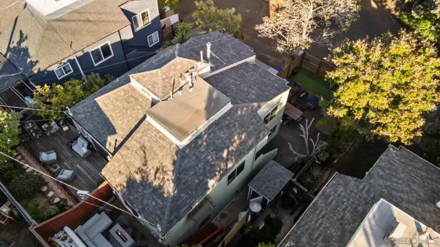 an aerial view of a house with a yard