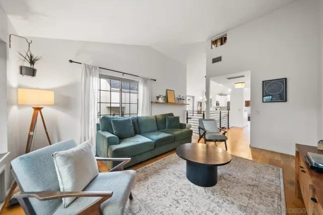 a living room with furniture a rug and a chandelier