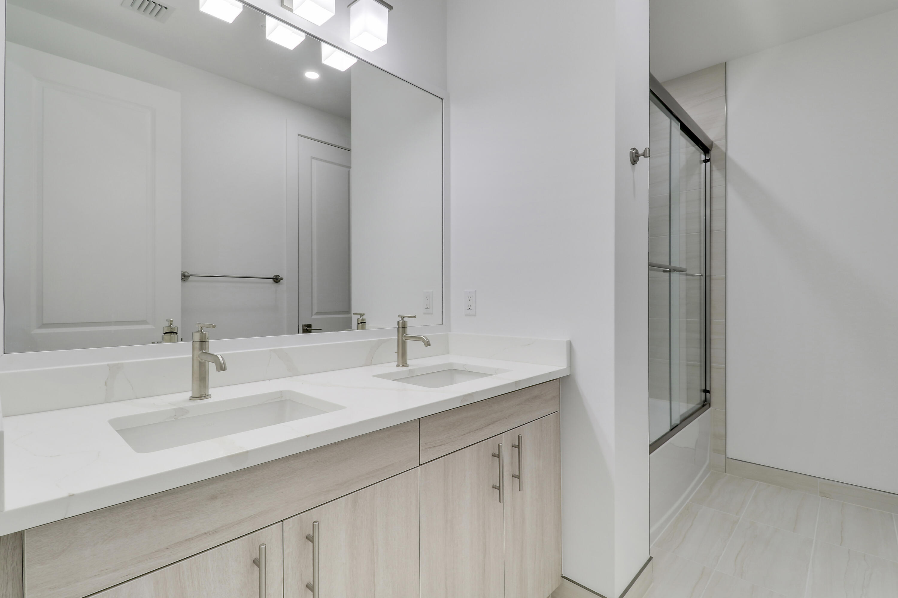 120 Water Pointe Place, Unit 3 Jupiter, FL 33477 - Photo 13 of 36 a bathroom with a sink double vanity and a mirror