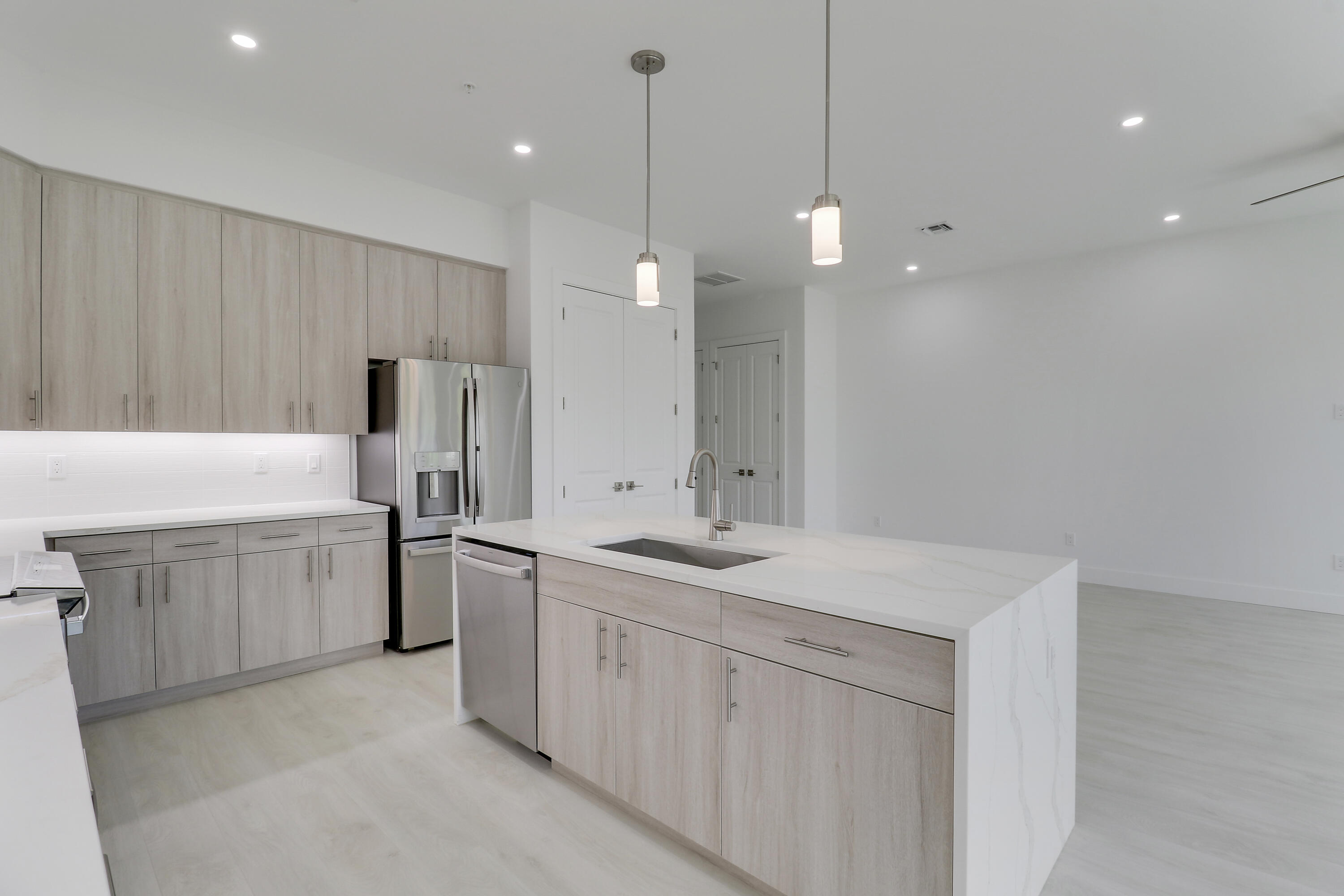 120 Water Pointe Place, Unit 3 Jupiter, FL 33477 - Photo 31 of 36 a kitchen with a sink and refrigerator