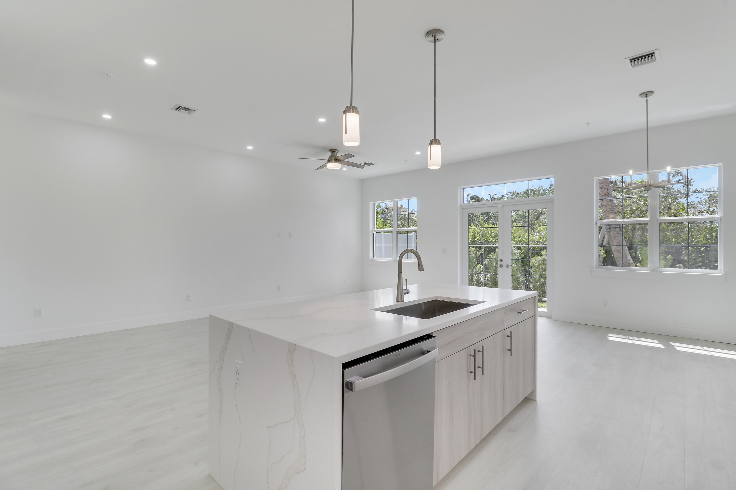 120 Water Pointe Place, Unit 3 Jupiter, FL 33477 - Photo 33 of 36 a kitchen with a sink chandelier and window