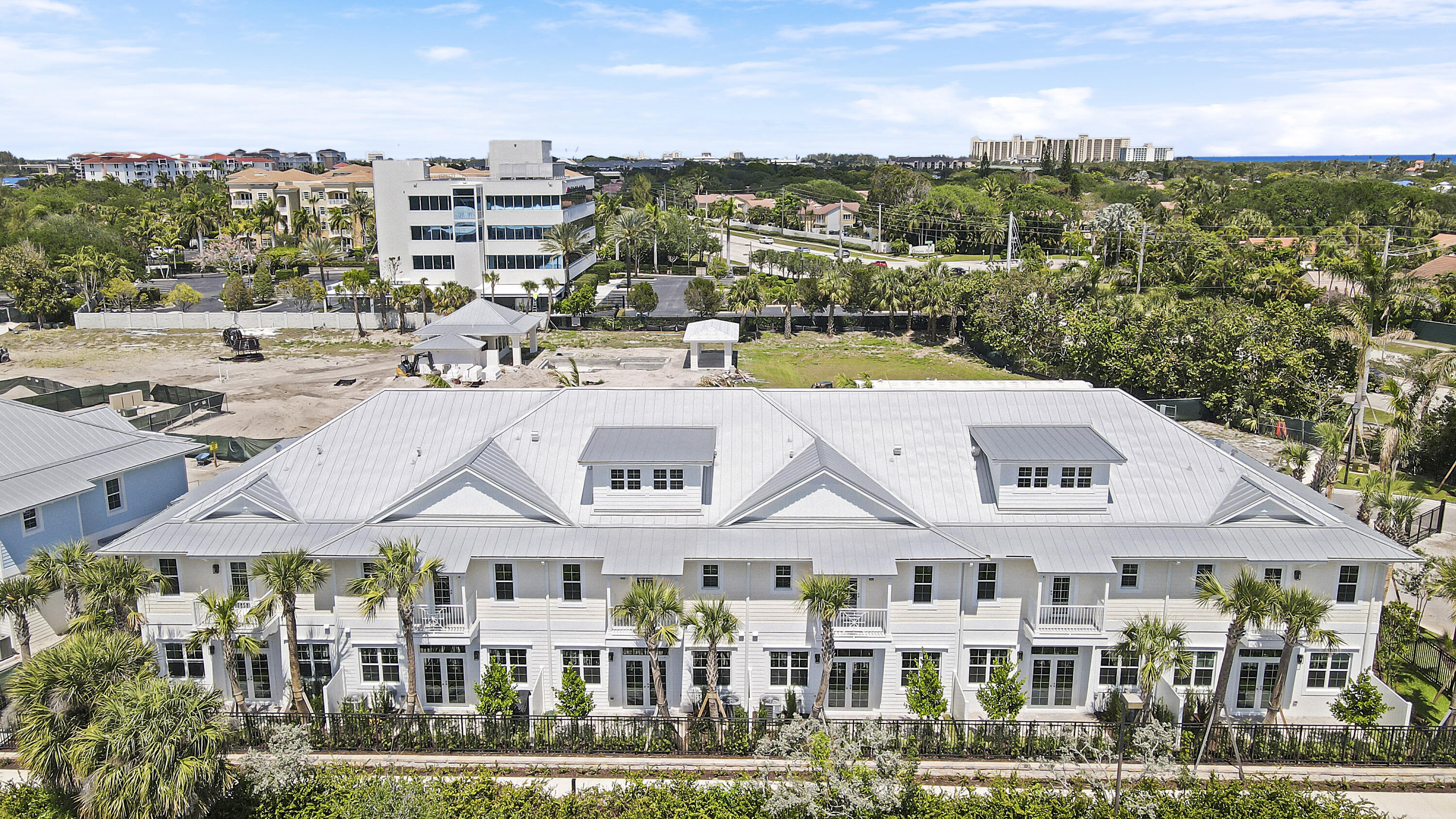 120 Water Pointe Place, Unit 3 Jupiter, FL 33477 - Photo 9 of 36 a view of a large building with a lot of windows and covered with trees