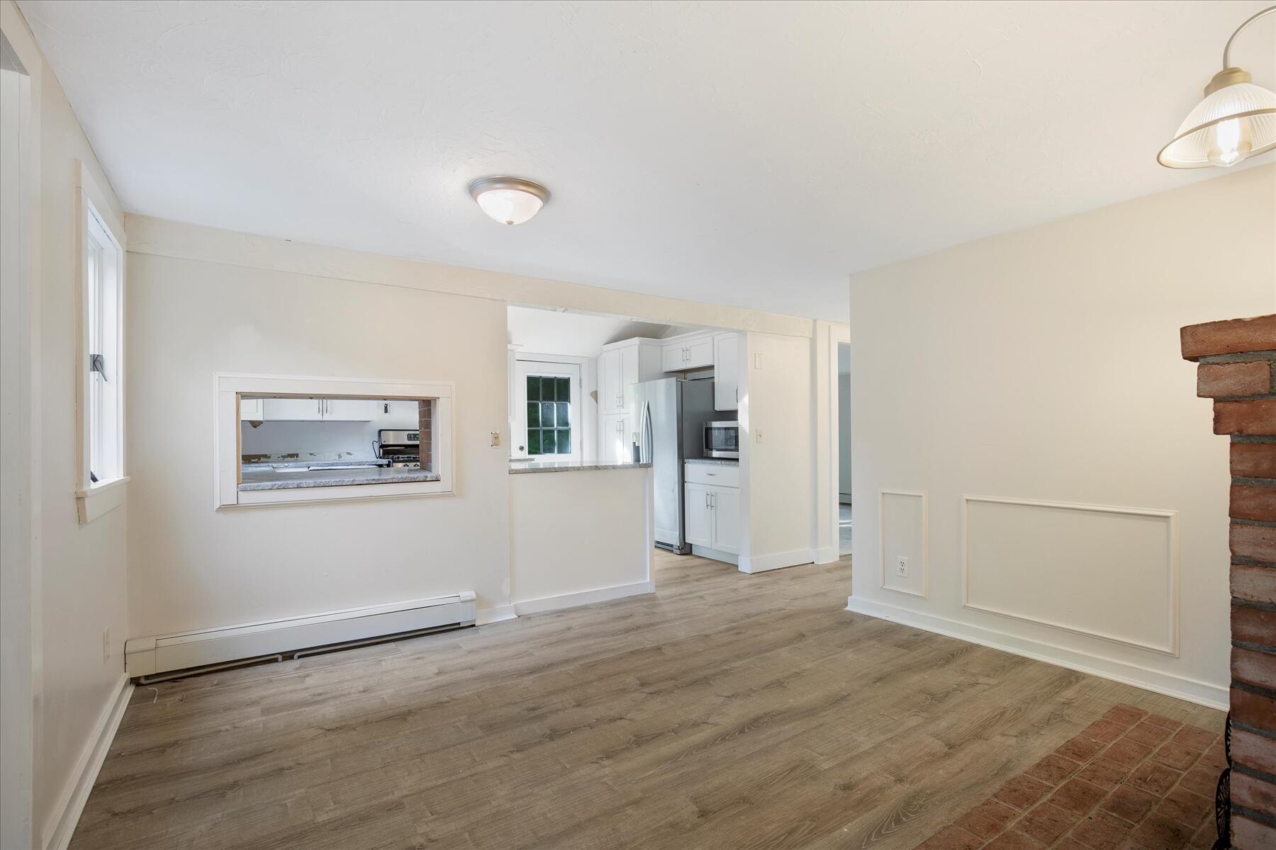 254 Barlows Landing Road Pocasset, MA 02559 - Photo 7 of 27 an empty room with wooden floor and windows