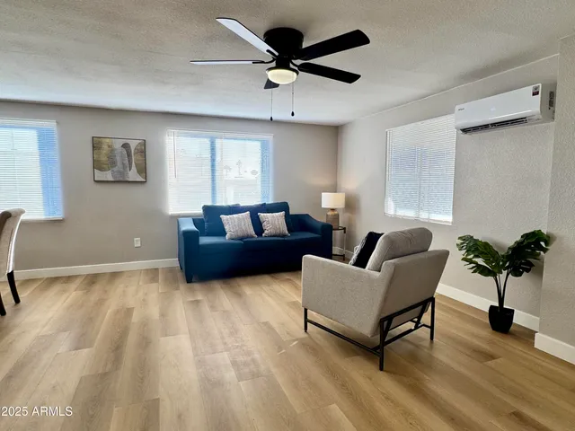 a living room with furniture and a potted plant