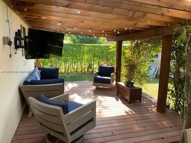 a outdoor living space with furniture tv and garden view