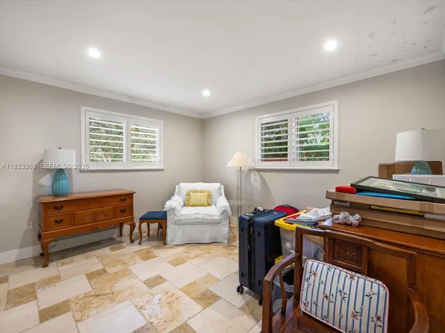 a bedroom with furniture and a window