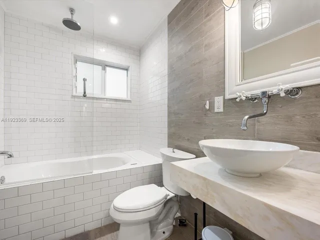 a bathroom with a sink a toilet and bathtub
