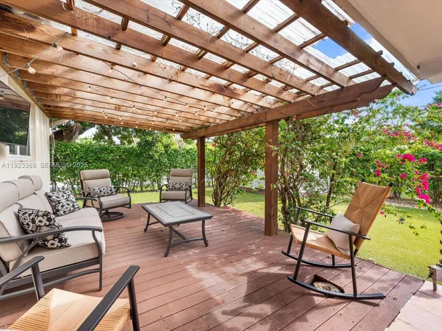 a view of a dining room with furniture and a garden