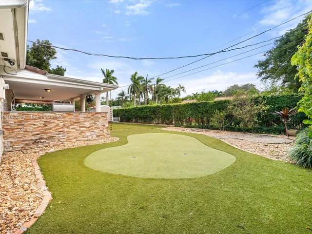 an aerial view of a house with a garden and lake view