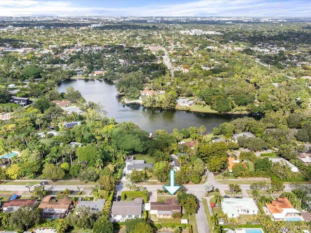 an aerial view of multiple houses with yard