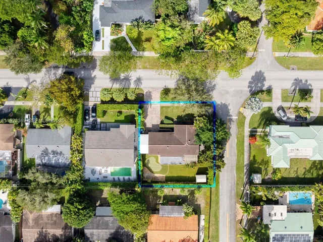 an aerial view of residential houses with outdoor space
