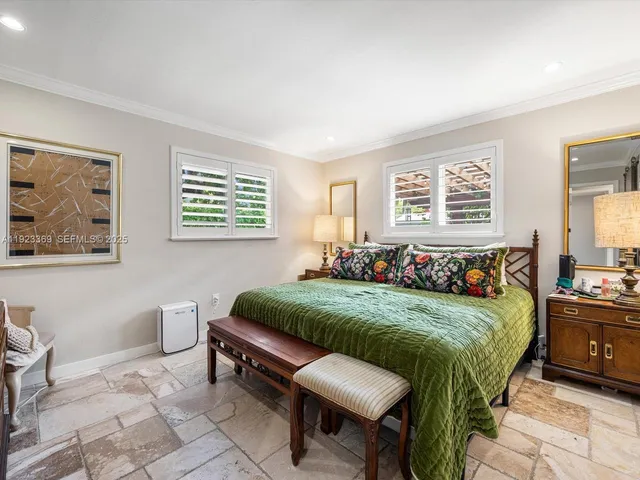 a living room with a bed furniture and a window