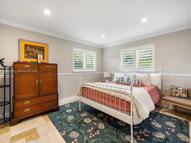 a bed room with a bed and two windows