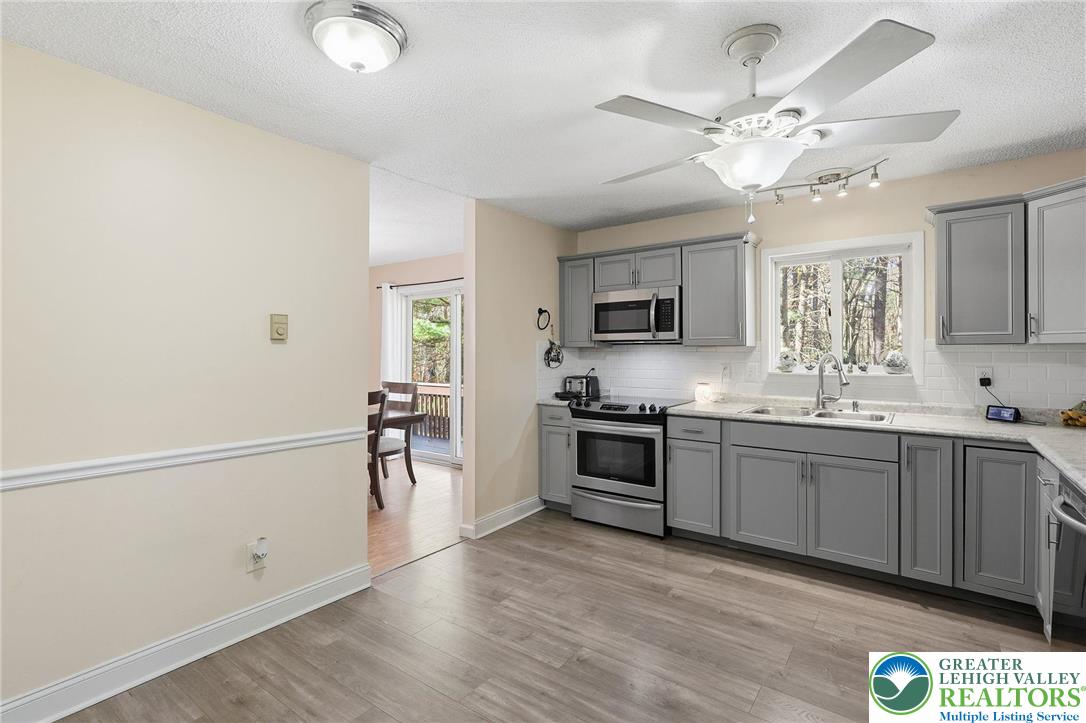 104 Scotch Pine Court Dingmans Ferry, PA 18328 - Photo 11 of 41 a large kitchen with cabinets wooden floor and stainless steel appliances