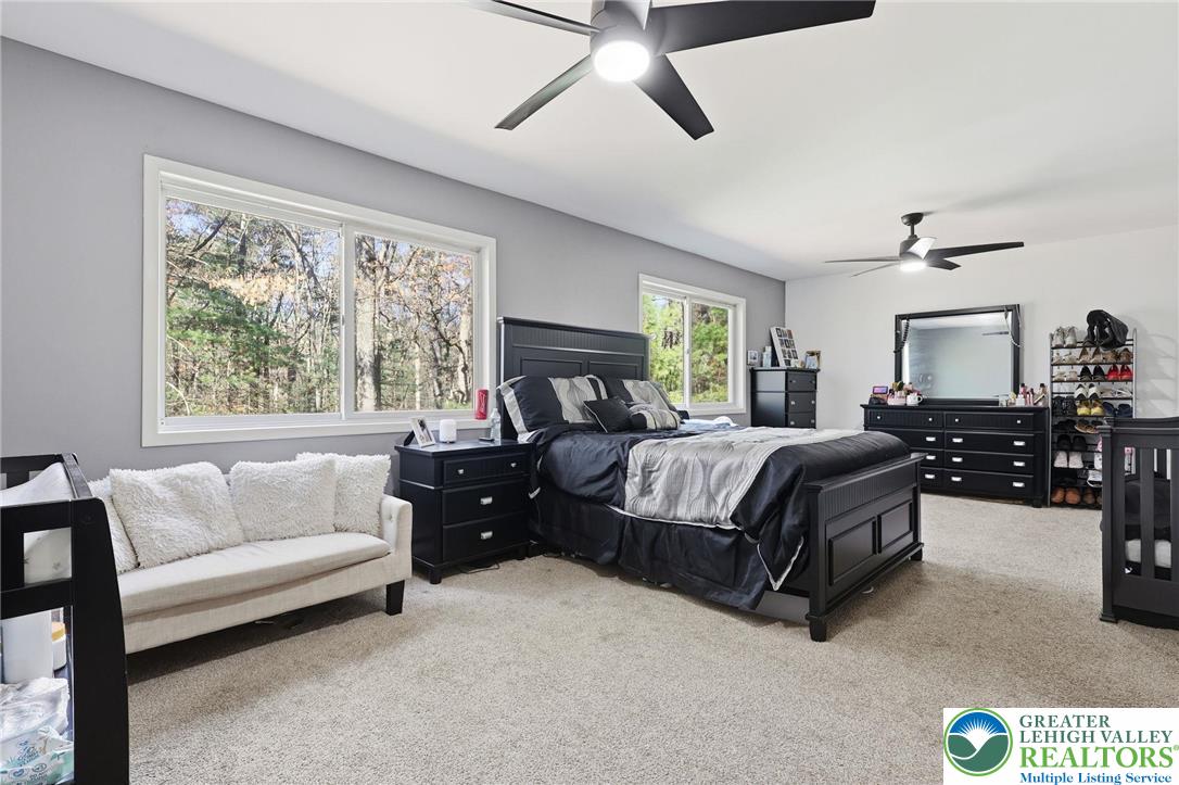 104 Scotch Pine Court Dingmans Ferry, PA 18328 - Photo 14 of 41 a bedroom with a bed couch and window