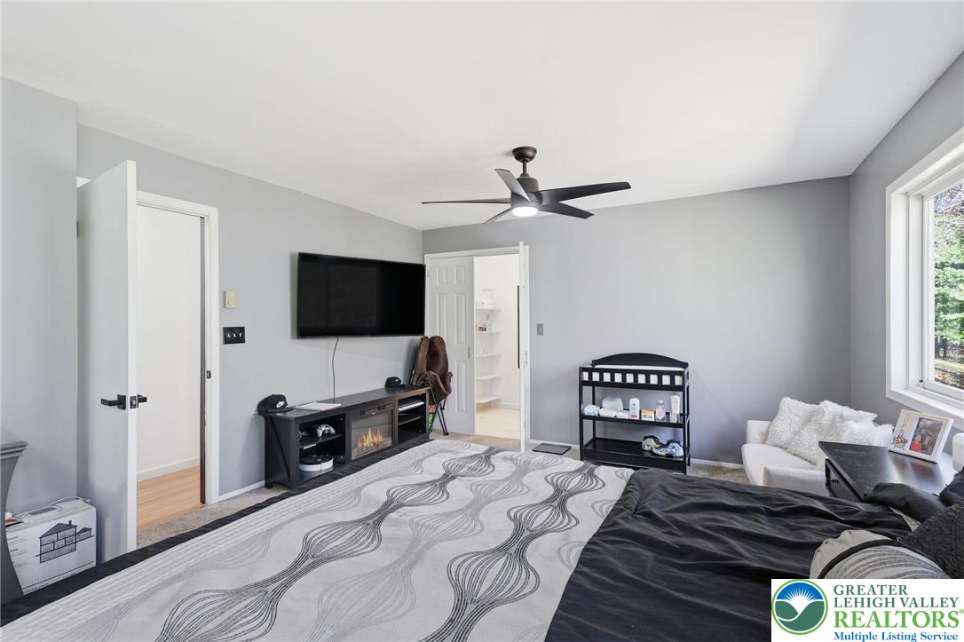 104 Scotch Pine Court Dingmans Ferry, PA 18328 - Photo 16 of 41 a bedroom with a bed and a flat screen tv