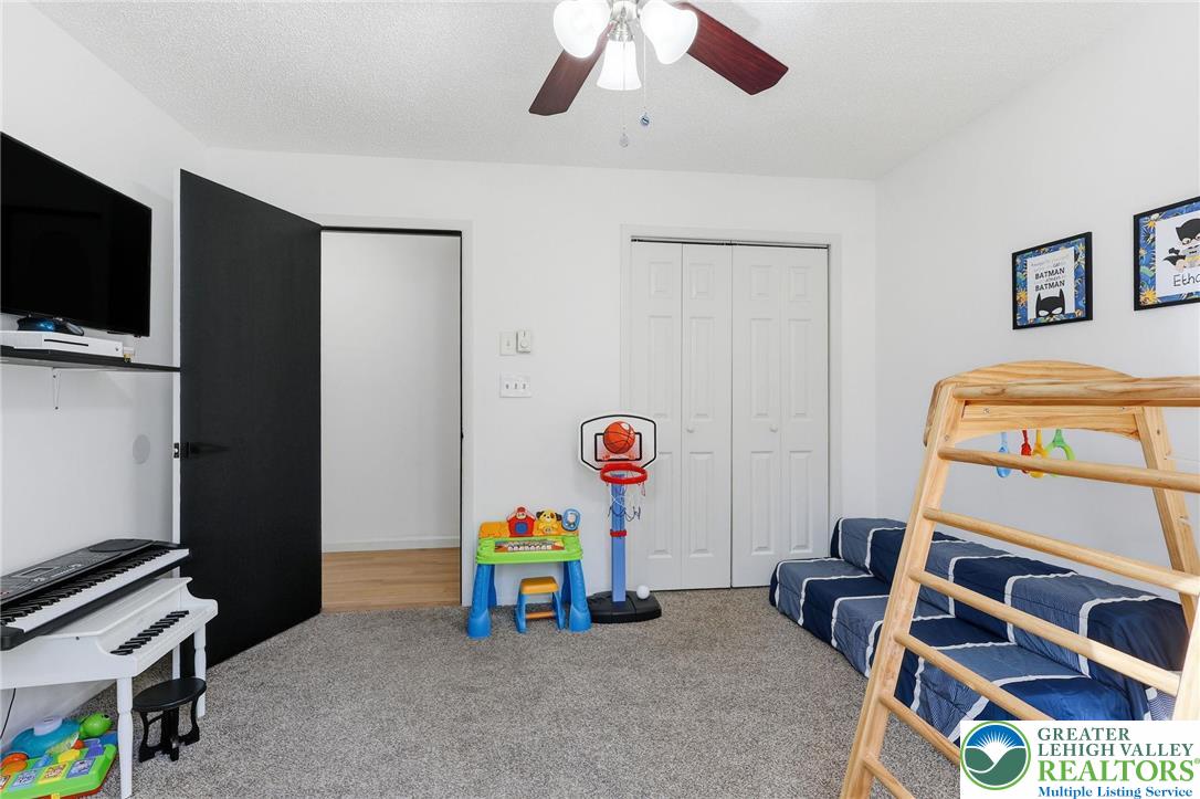 104 Scotch Pine Court Dingmans Ferry, PA 18328 - Photo 19 of 41 a bedroom with a bed and a tv