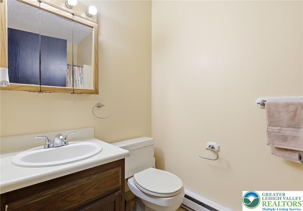 104 Scotch Pine Court Dingmans Ferry, PA 18328 - Photo 20 of 41 a bathroom with a sink a toilet and mirror