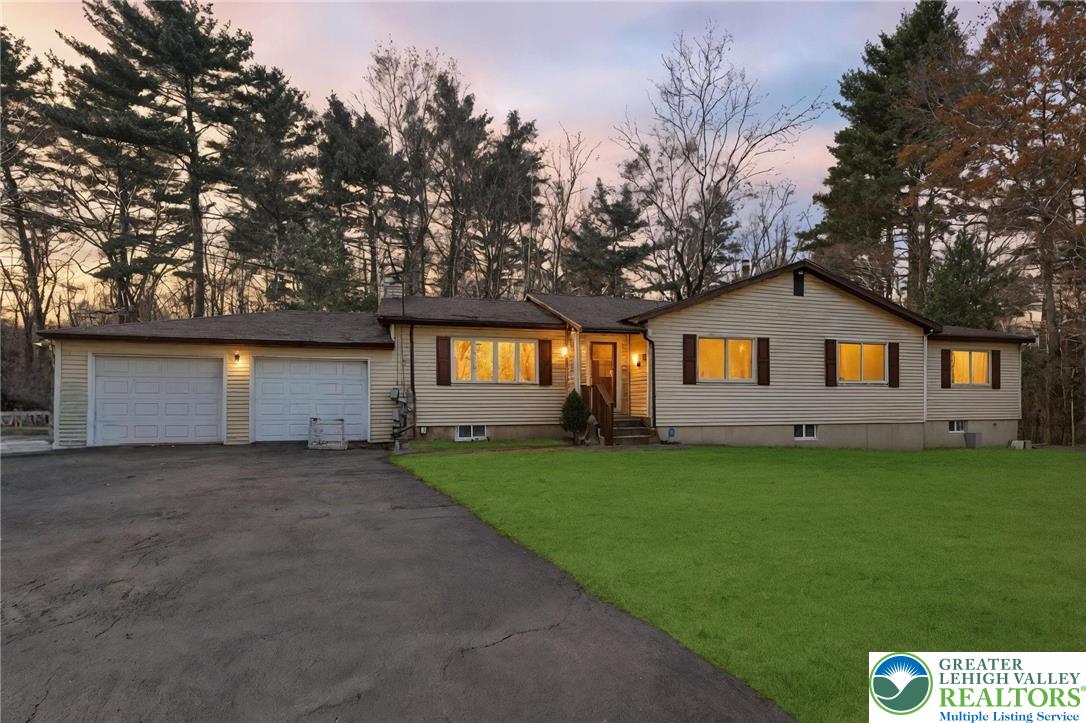 104 Scotch Pine Court Dingmans Ferry, PA 18328 - Photo 2 of 41 a front view of a house with a yard and garage