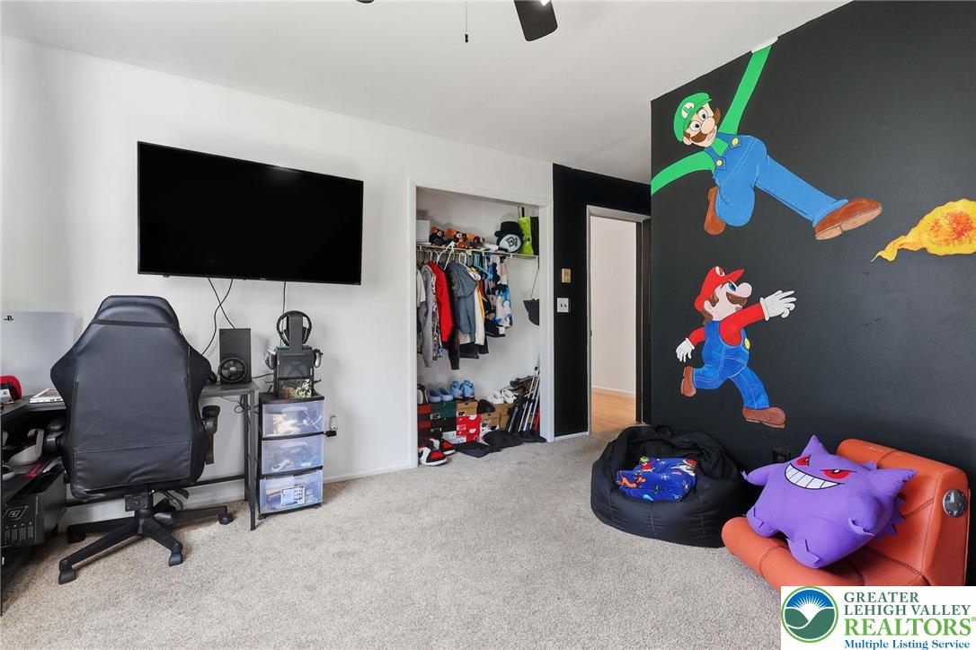 104 Scotch Pine Court Dingmans Ferry, PA 18328 - Photo 21 of 41 a bedroom with a bed and a flat screen tv