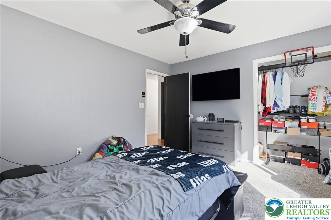 104 Scotch Pine Court Dingmans Ferry, PA 18328 - Photo 23 of 41 a bedroom with a bed and a flat screen tv