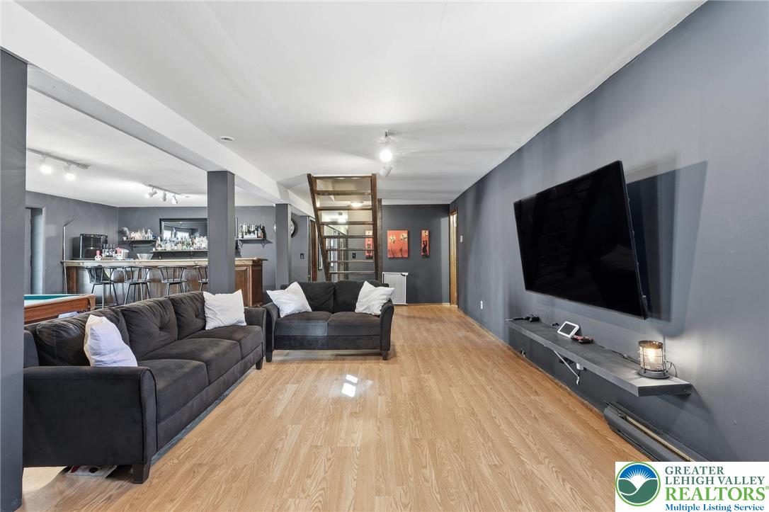 104 Scotch Pine Court Dingmans Ferry, PA 18328 - Photo 27 of 41 a living room with furniture and a flat screen tv