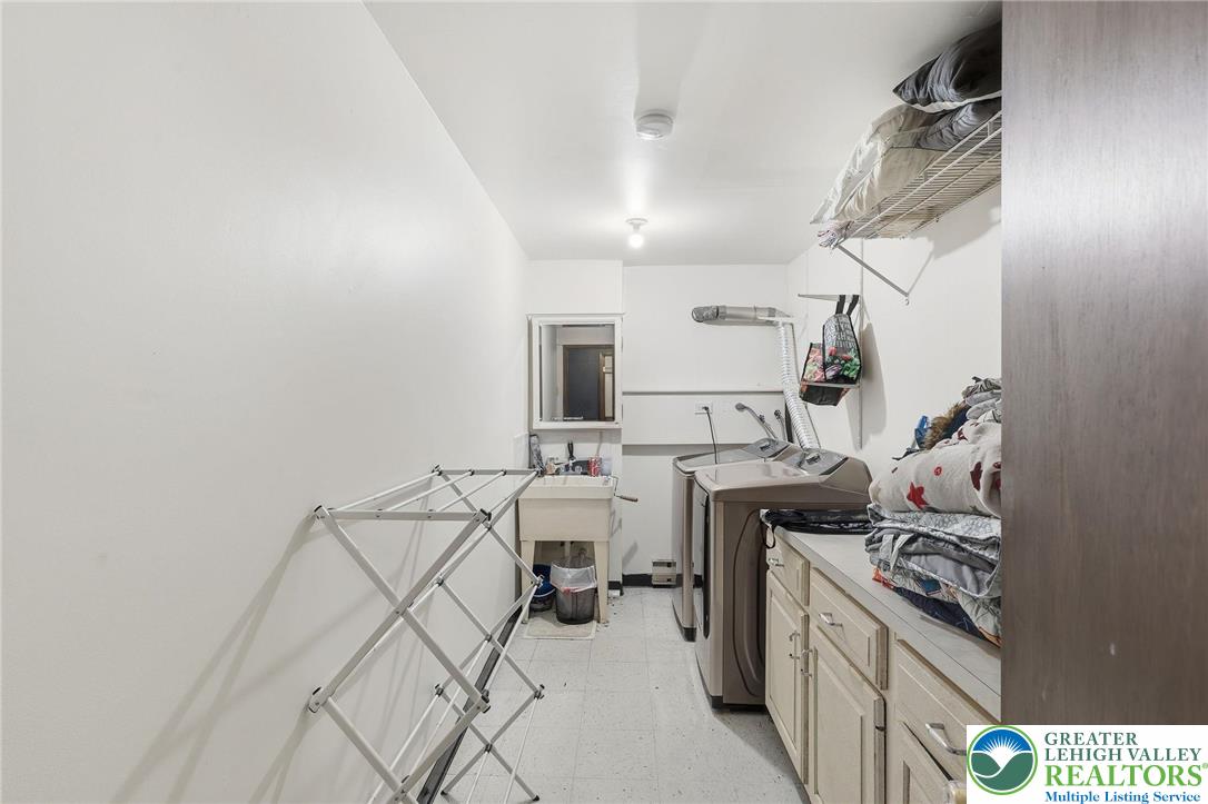 104 Scotch Pine Court Dingmans Ferry, PA 18328 - Photo 28 of 41 a kitchen with cabinets and chairs