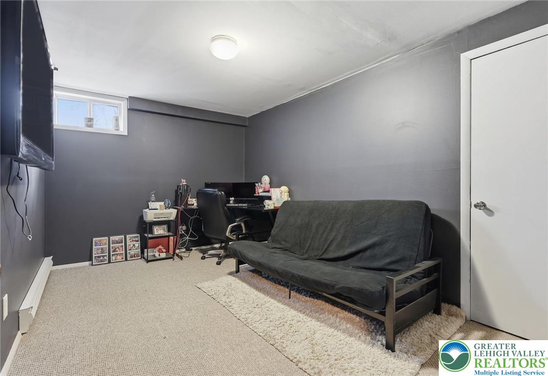 104 Scotch Pine Court Dingmans Ferry, PA 18328 - Photo 31 of 41 a living room with furniture and a chair