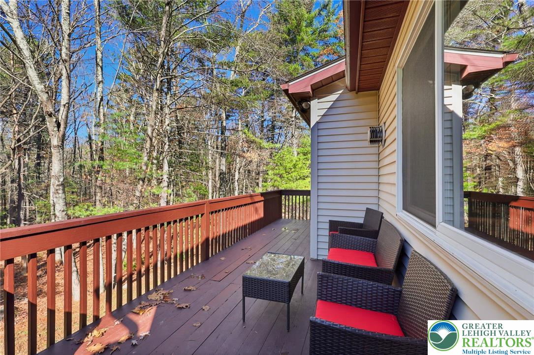 104 Scotch Pine Court Dingmans Ferry, PA 18328 - Photo 35 of 41 a balcony with wooden floor and outdoor seating