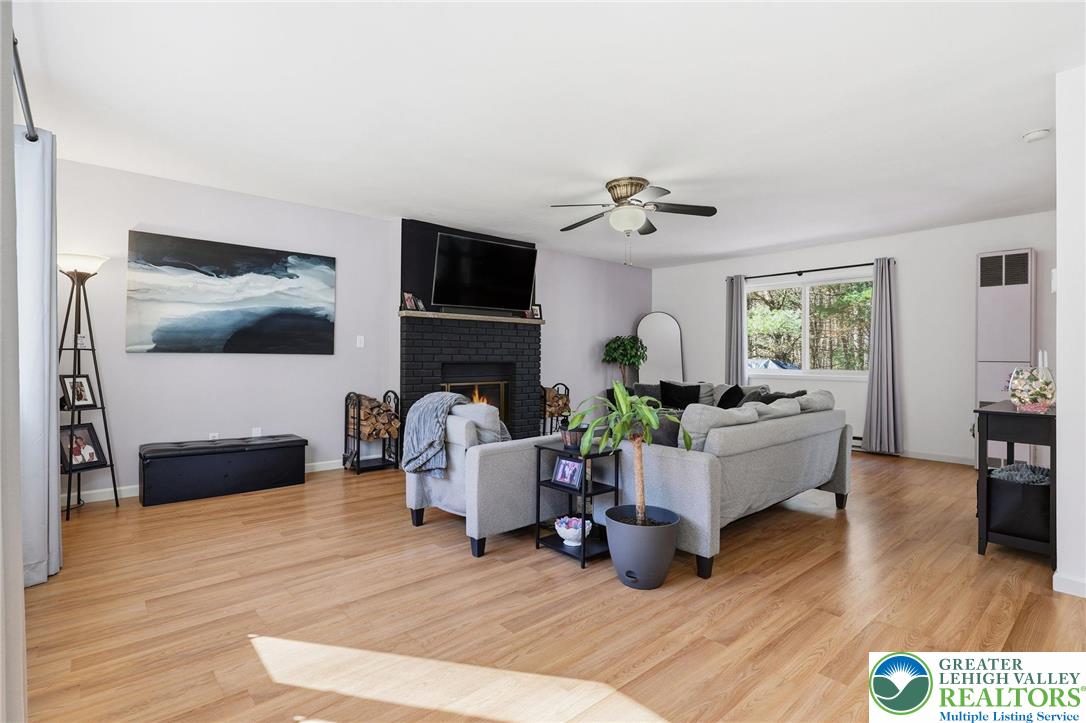 104 Scotch Pine Court Dingmans Ferry, PA 18328 - Photo 4 of 41 a living room with furniture and a wooden floor