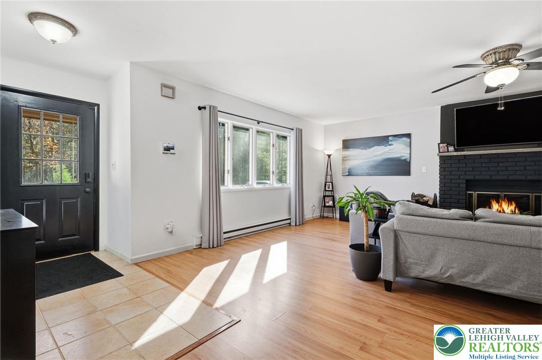 104 Scotch Pine Court Dingmans Ferry, PA 18328 - Photo 6 of 41 a living room with furniture and a fireplace