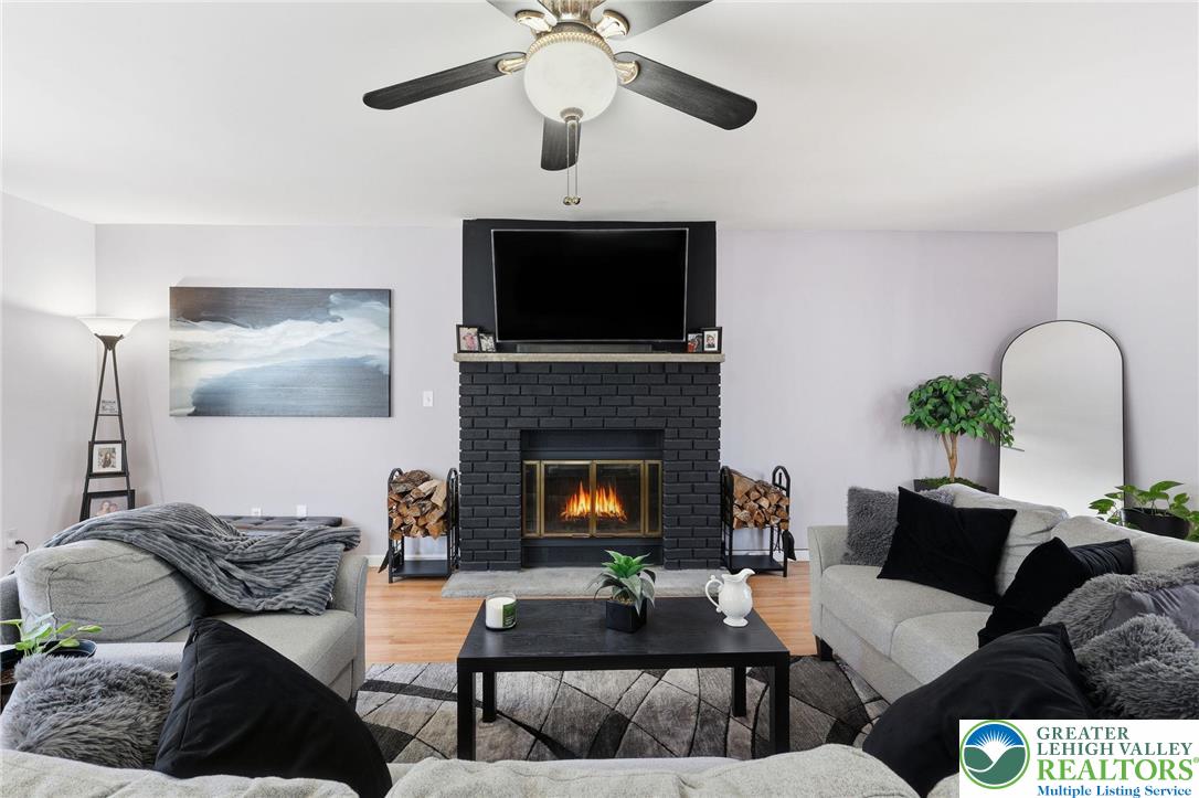 104 Scotch Pine Court Dingmans Ferry, PA 18328 - Photo 7 of 41 a living room with furniture and a fireplace