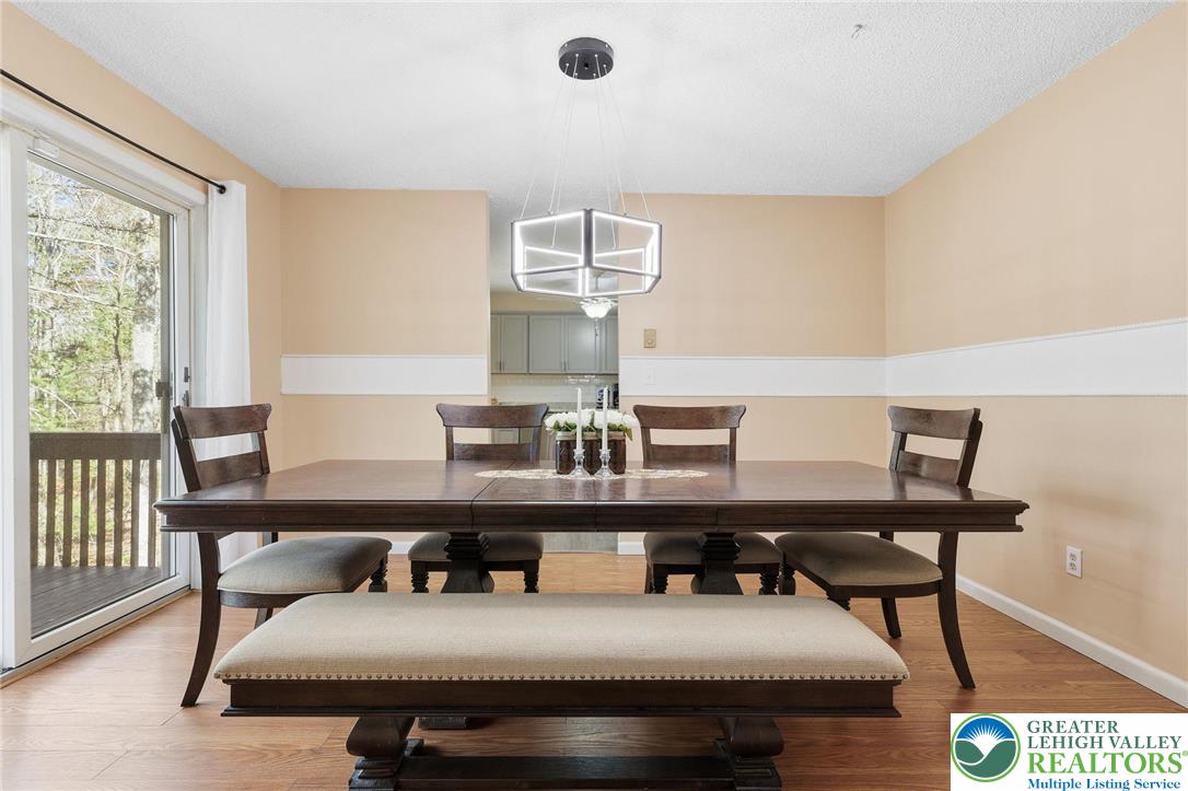 104 Scotch Pine Court Dingmans Ferry, PA 18328 - Photo 8 of 41 a view of a dining room with furniture and wooden floor