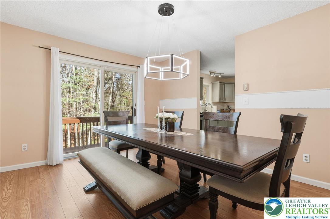 104 Scotch Pine Court Dingmans Ferry, PA 18328 - Photo 9 of 41 a view of a dining room with furniture window and outside view
