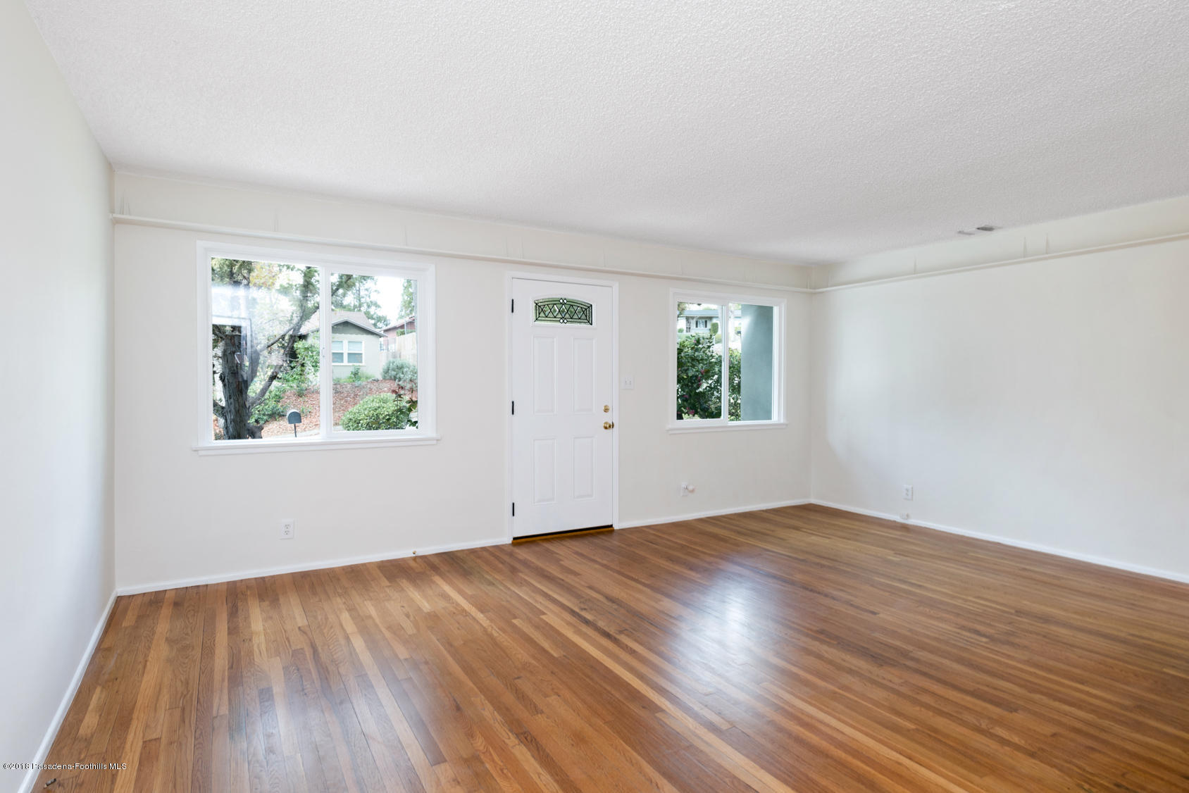 4286 Aralia Road Altadena, CA 91001 - Photo 2 of 22 an empty room with wooden floor and windows