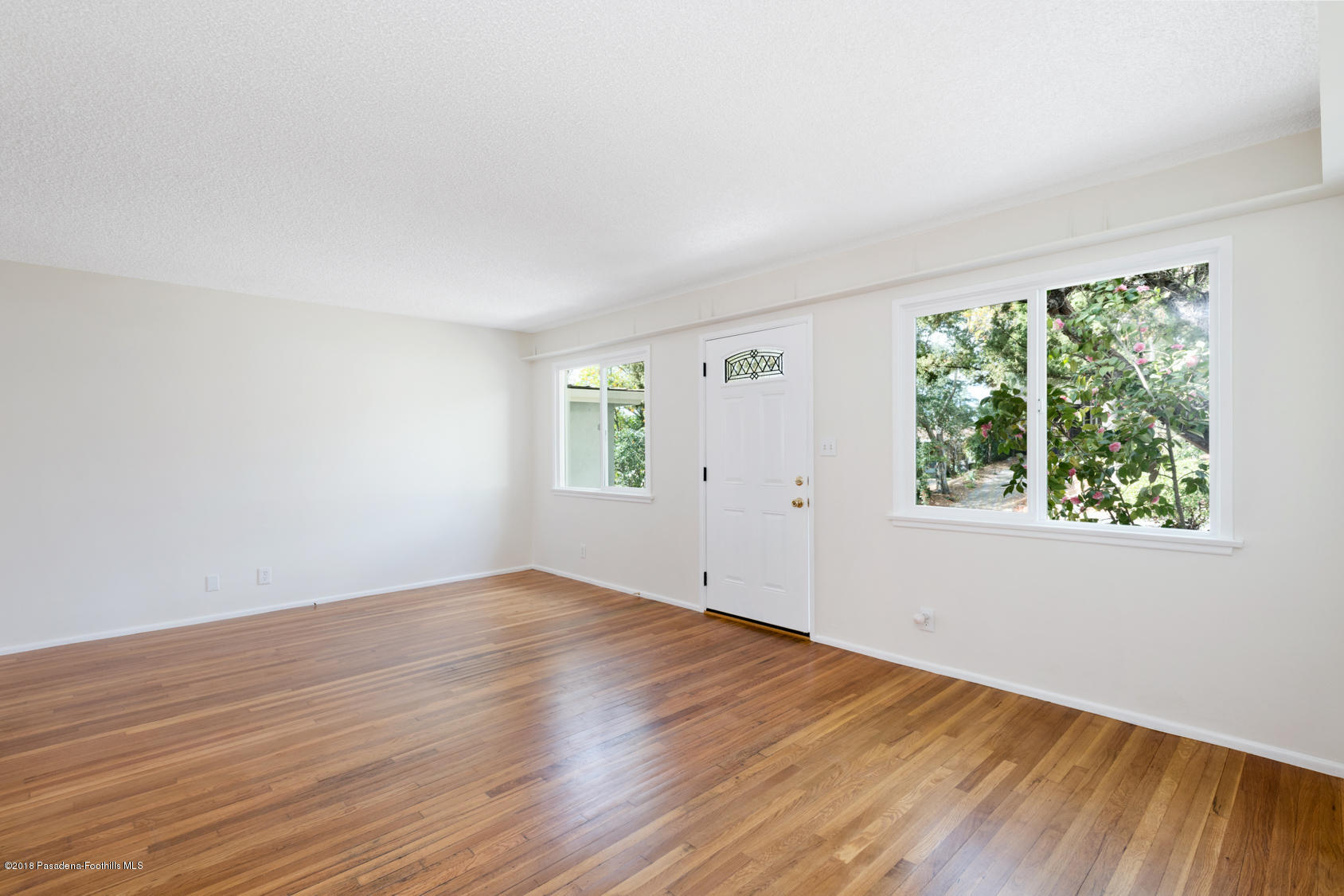4286 Aralia Road Altadena, CA 91001 - Photo 11 of 22 an empty room with wooden floor and windows