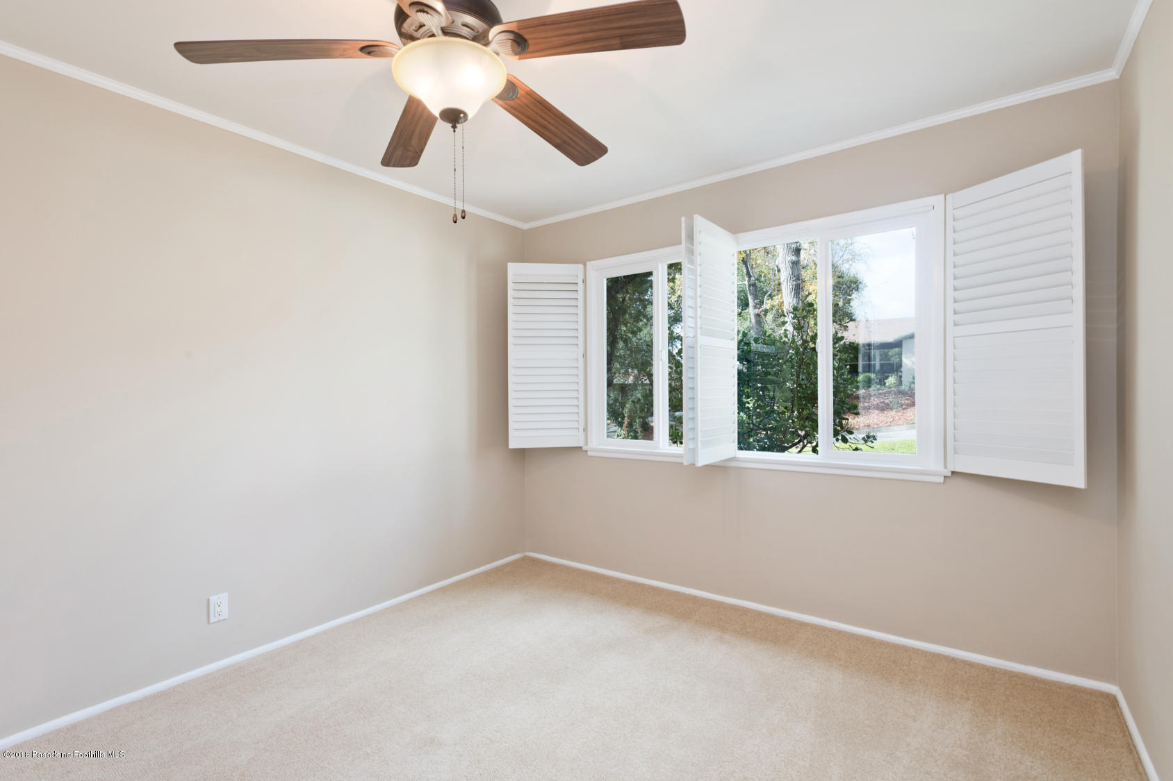 4286 Aralia Road Altadena, CA 91001 - Photo 17 of 22 an empty room with a window and a fan