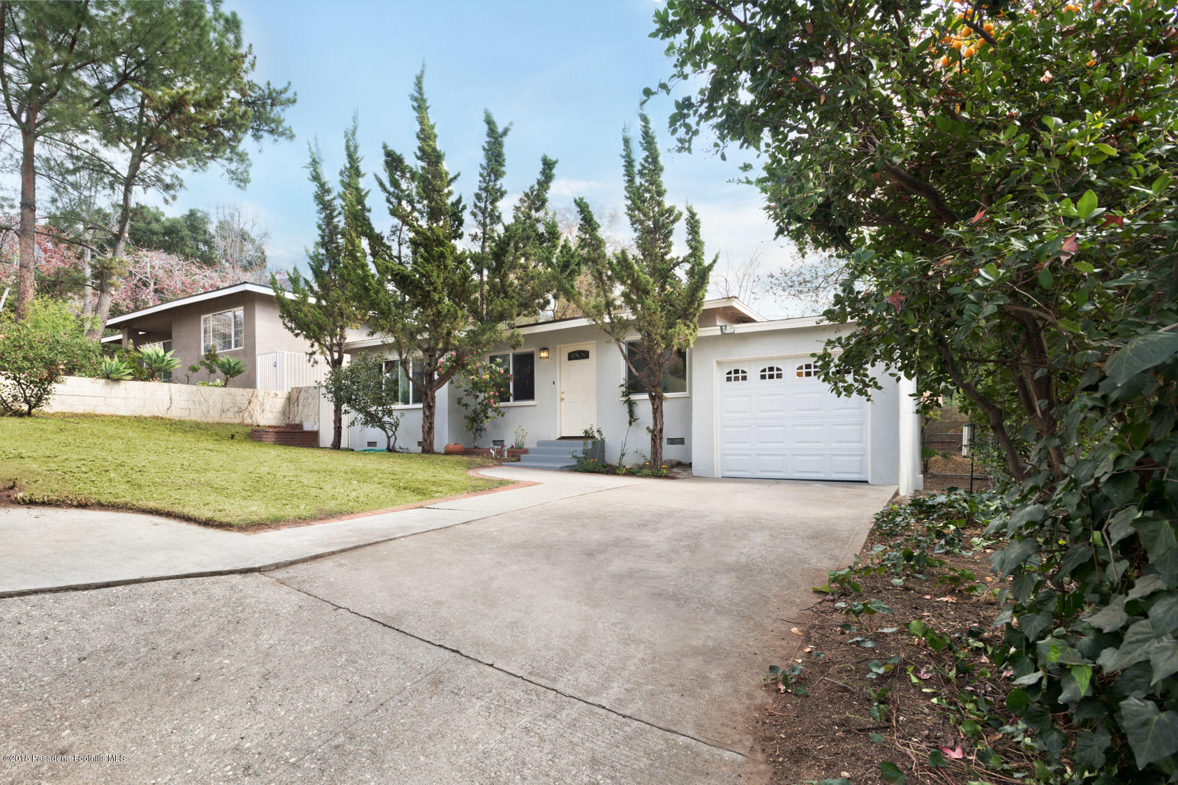 4286 Aralia Road Altadena, CA 91001 - Photo 20 of 22 a front view of a house with a yard and garage