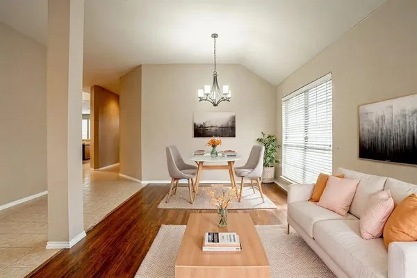 a living room with furniture and a chandelier
