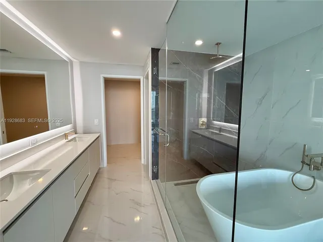 a bathroom with a tub and shower