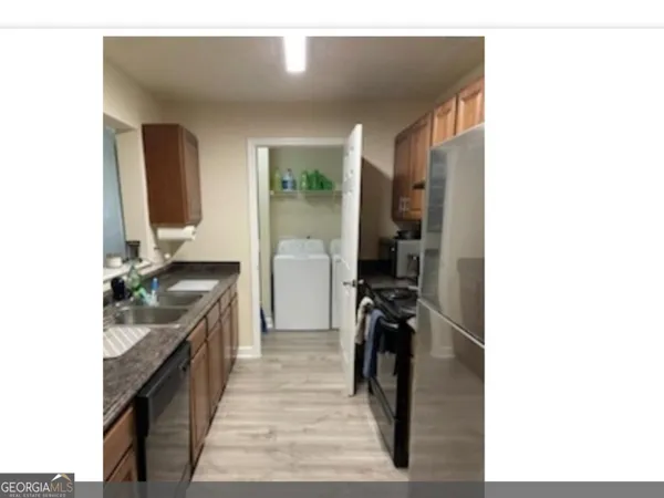 a en suite bathroom with a granite countertop sink and a mirror